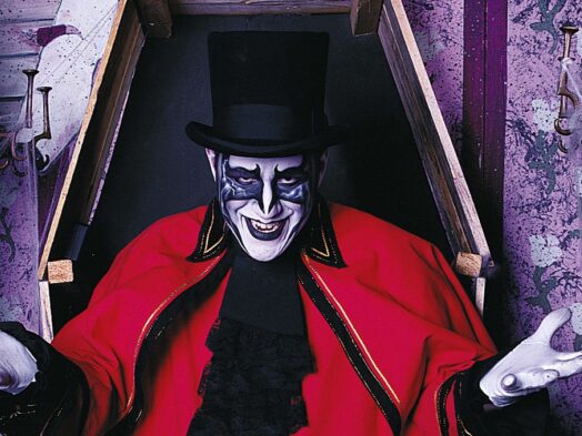 Darkus Knight, a ghoul character with a full painted face, black top hat and long red cape